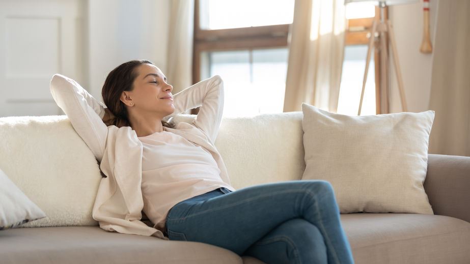 Woman relaxing inside comfortable living room