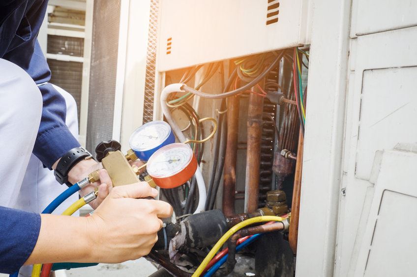 Technician working on HVAC unit