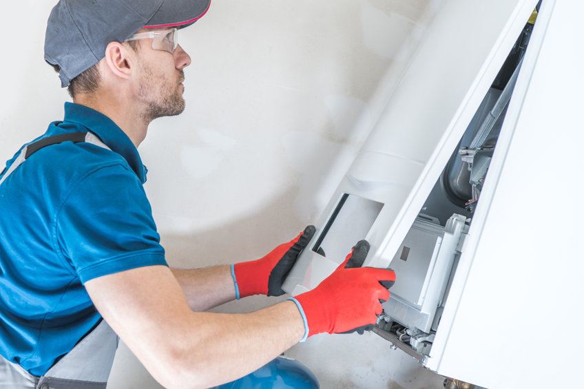 Technician repairing a furnace