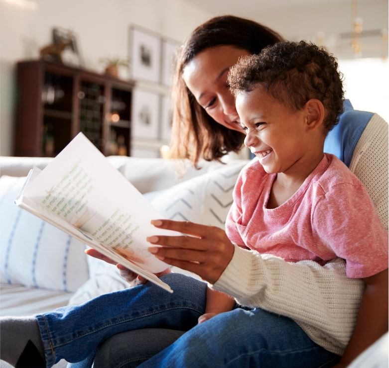 Mother reading a book to her son