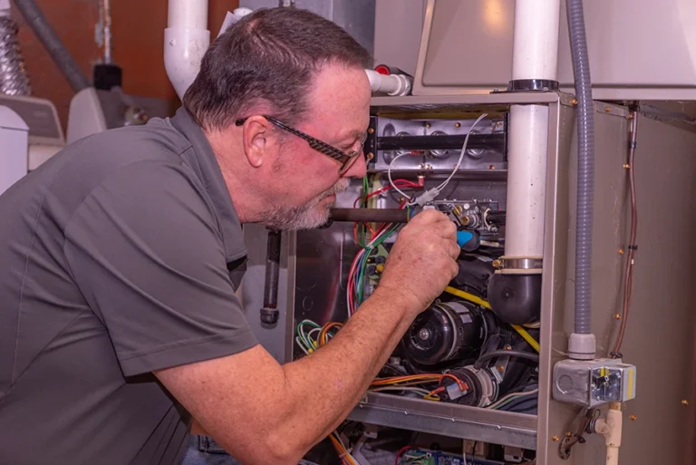 hvac technician working on furnace